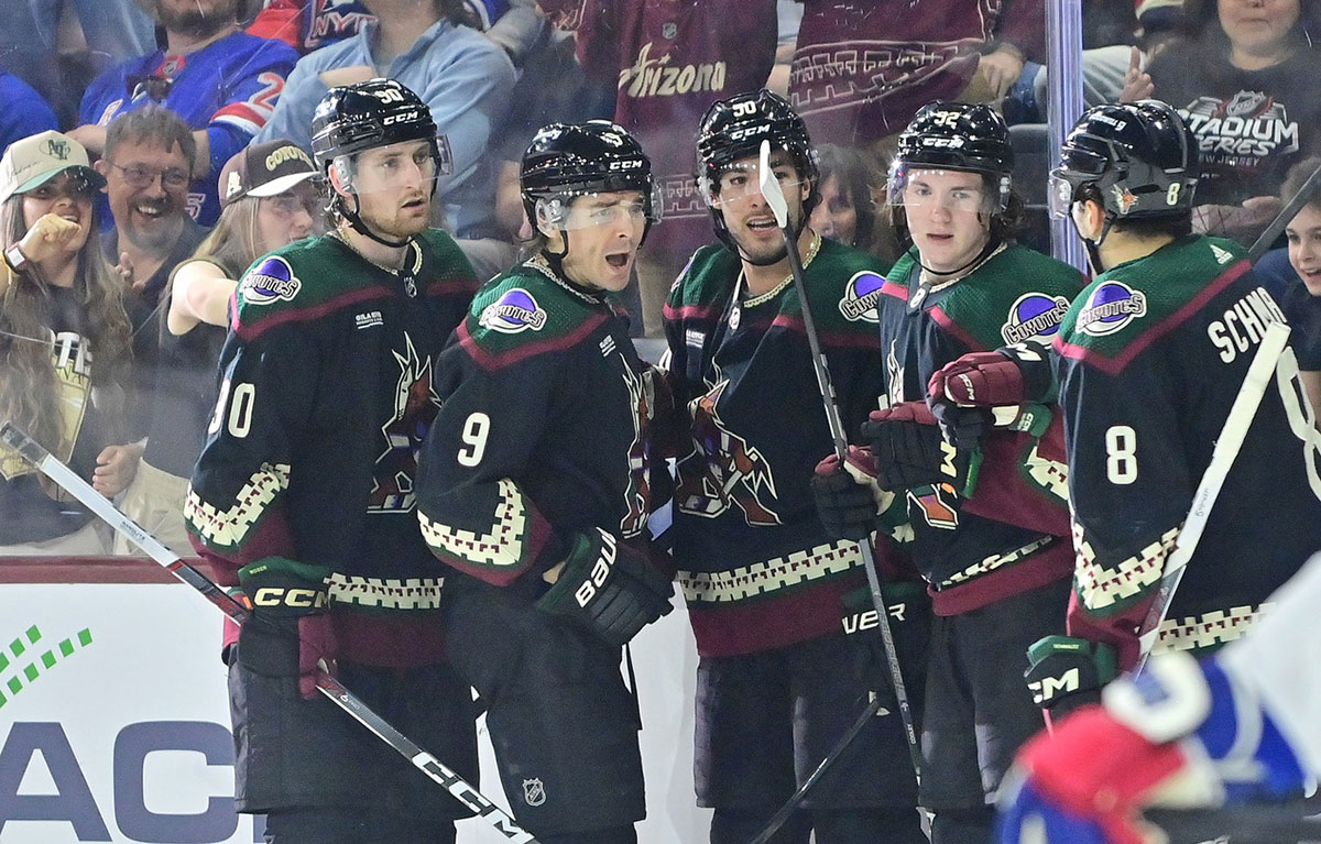 Arizona Coyotes right wing Clayton Keller (9) celebrates with defenseman J.J. Moser (90), defenseman Sean Durzi (50), center Logan Cooley (92), and center Nick Schmaltz (8) after scoring a goal in the second period against the New York Rangers at Mullett Arena.