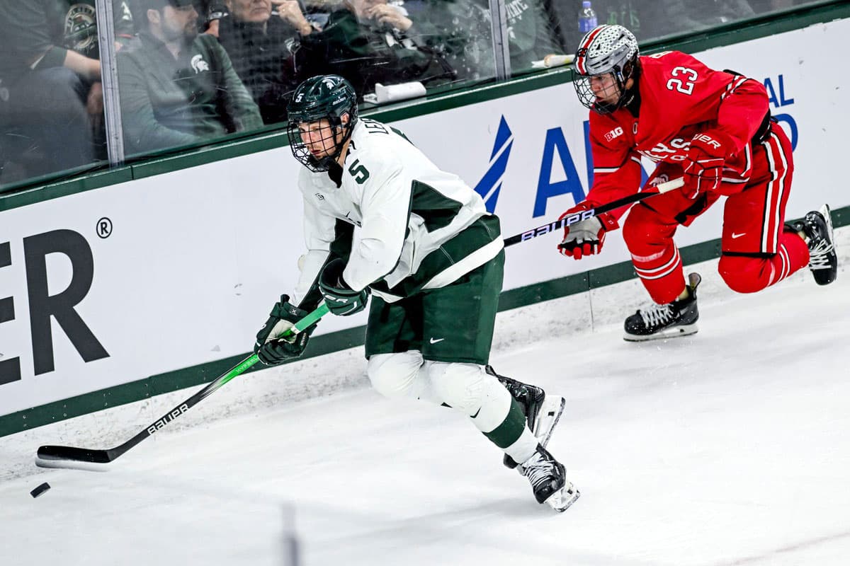 Michigan State's Artyom Levshunov, left, moves the puck as Ohio State's Davis Burnside closes in during the first period of the Big Ten tournament game on Saturday, March 16, 2024, at Munn Arena in East Lansing.