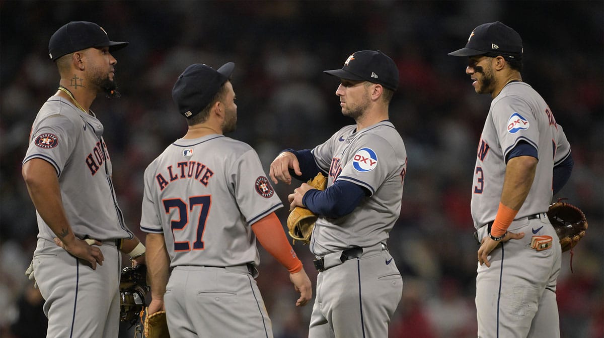 Houston Astros first baseman Jose Abreu (79), second baseman Jose Altuve (27), third baseman Alex Bregman (2) and shortstop Jeremy Pena (3) talk on the field during a pitching change in the eighth inning against the Los Angeles Angels at Angel Stadium