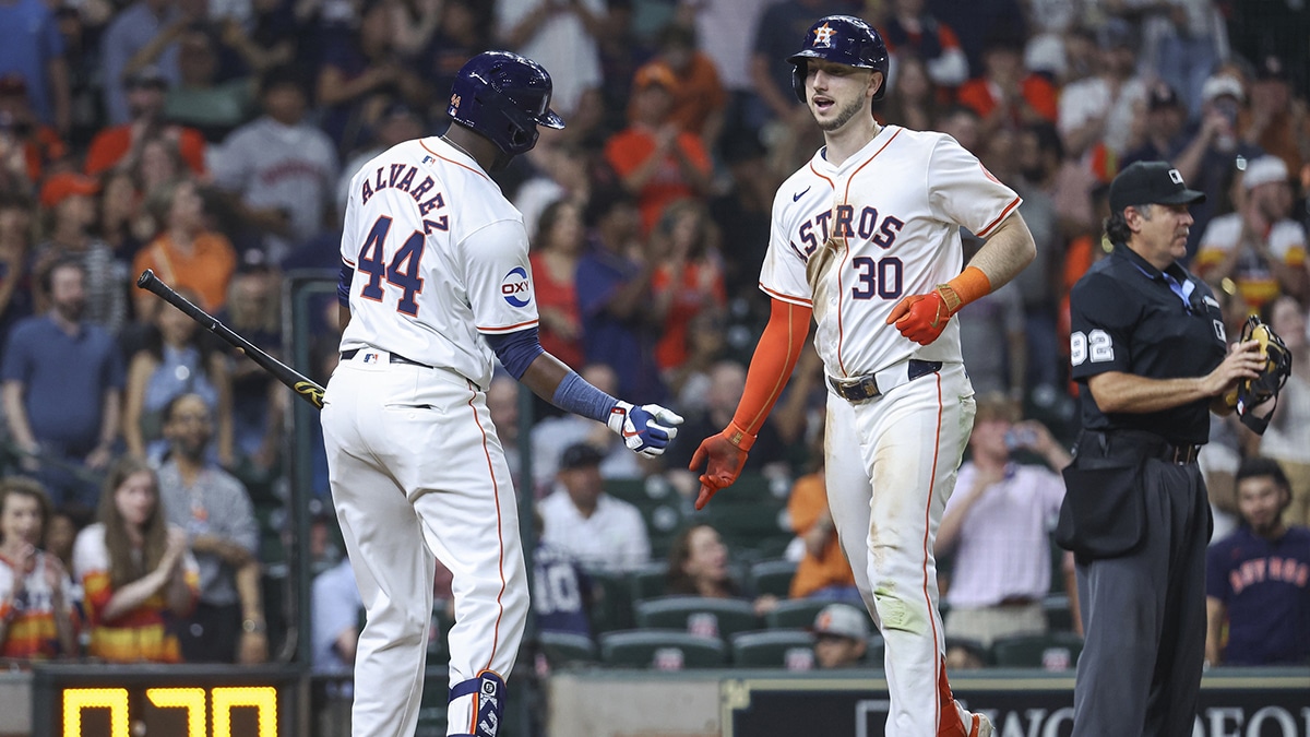 Houston Astros right fielder Kyle Tucker (30) celebrates with designated hitter Yordan Alvarez (44) after hitting a home run during the seventh inning against the Los Angeles Angels at Minute Maid Park.