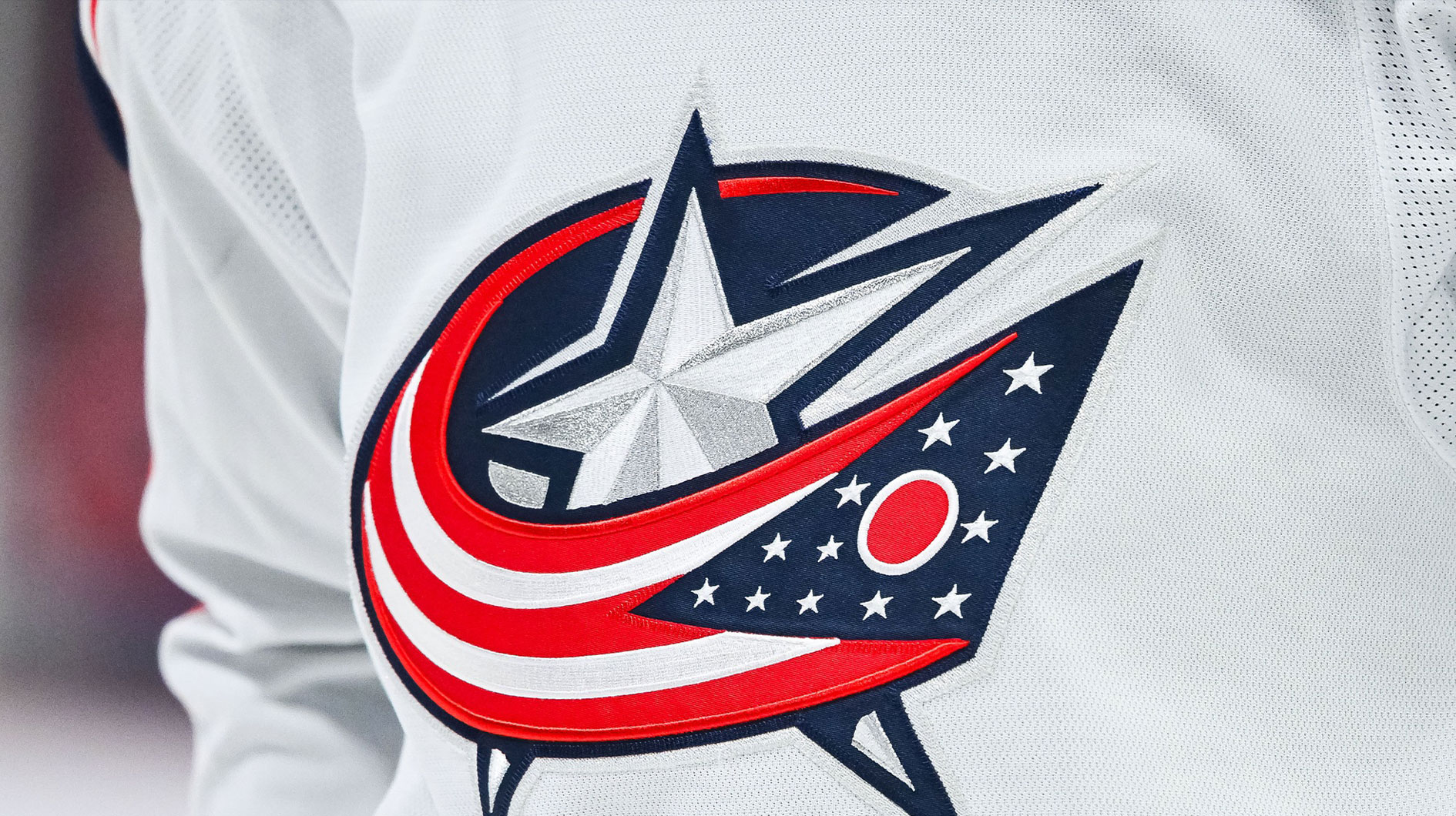 View of a Columbus Blue Jackets logo on a jersey worn by a member of the team during warm-up before the game against the Montreal Canadiens at Bell Centre.