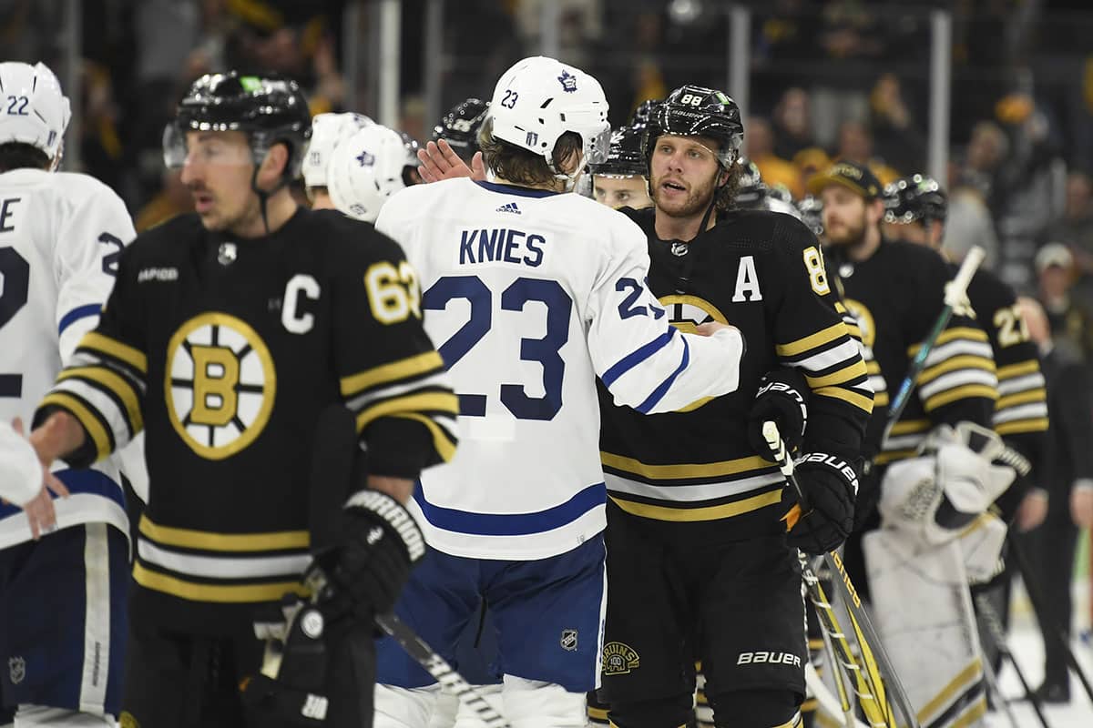 Toronto Maple Leafs left wing Matthew Knies (23) and Boston Bruins right wing David Pastrnak (88) speak after the Bruins defeated the Leafs in overtime in game seven of the first round of the 2024 Stanley Cup Playoffs at TD Garden.