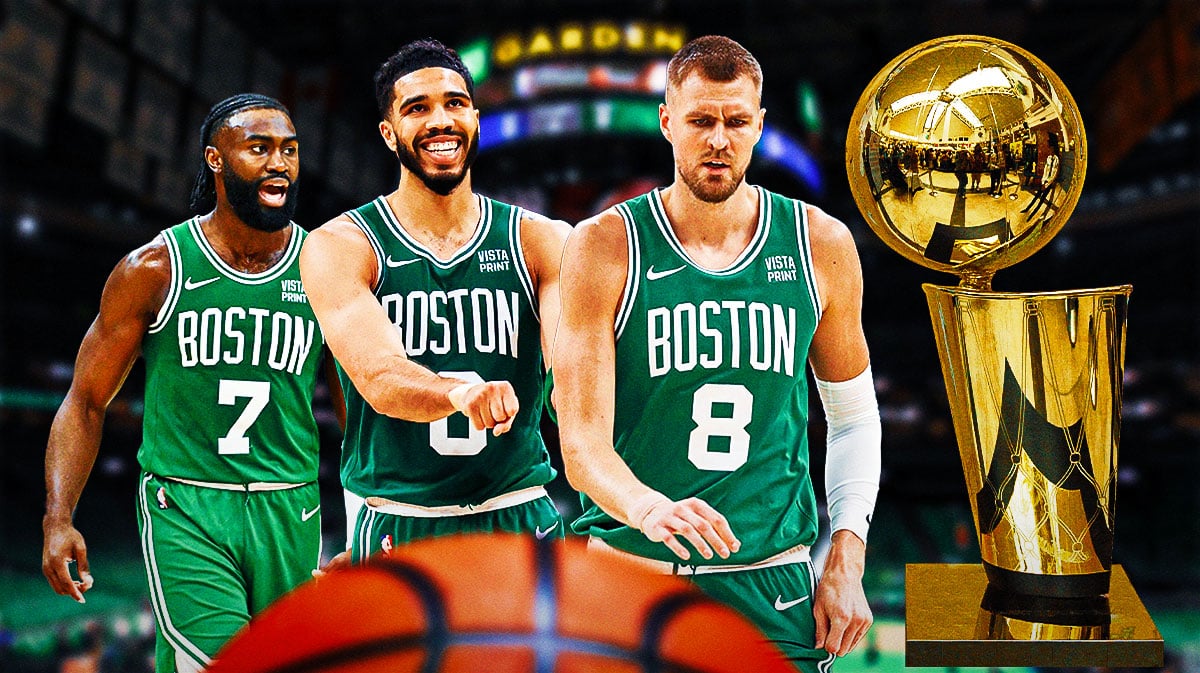 Jaylen Brown, Jayson Tatum and Kristaps Porzingis with Larry O'Brien trophy in background