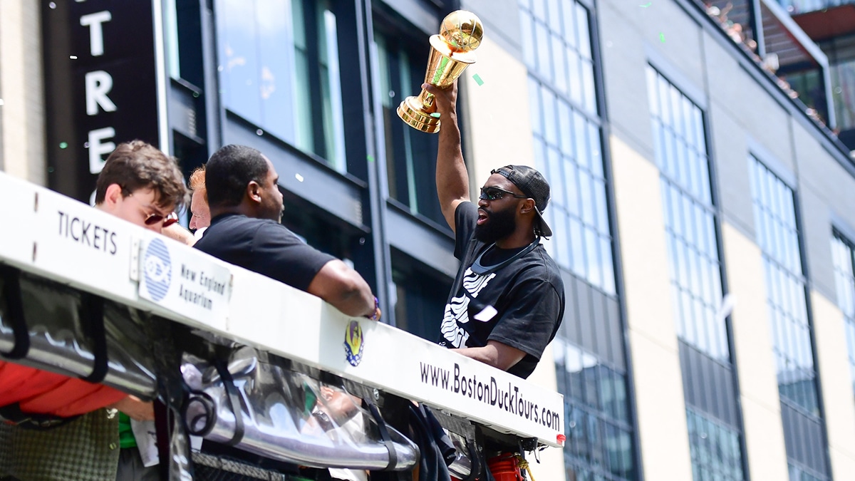 Jun 21, 2024; Boston, MA, USA; Boston Celtics player Jaylen Brown holds the MVP trophy during the Boston Celtics Championship parade. Mandatory Credit: Bob DeChiara-USA TODAY Sports