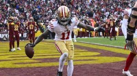 San Francisco 49ers wide receiver Brandon Aiyuk (11) celebrates after scoring a touchdown against the Washington Commanders during the second half at FedExField.