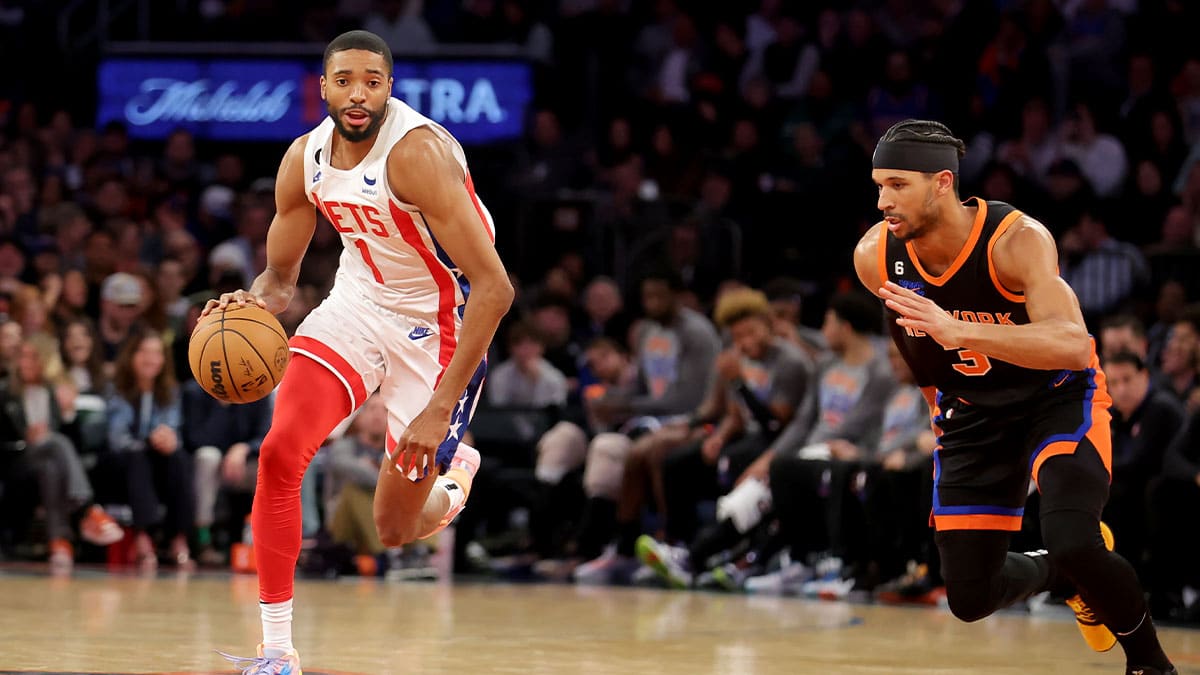 Brooklyn Nets forward Mikal Bridges brings the ball up court against New York Knicks guard Josh Hart