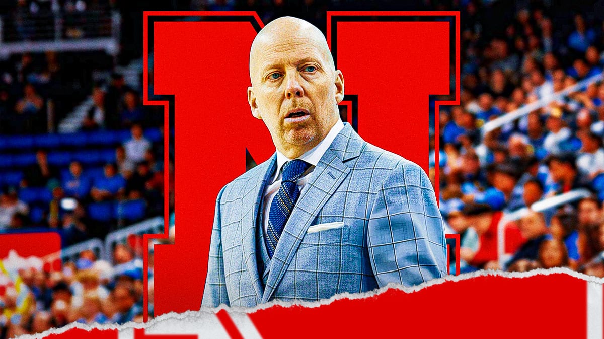 UCLA basketball, UCLA Basketball Coach Mick Cronin, Nebraska basketball logo behind him.