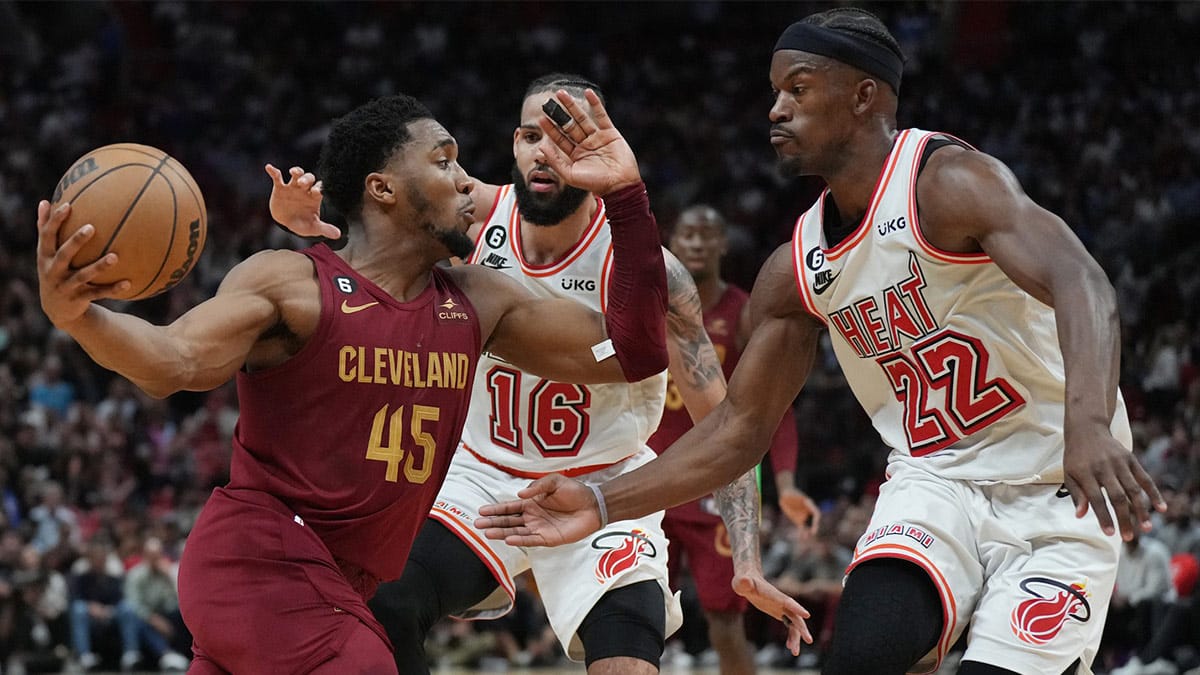 Cleveland Cavaliers guard Donovan Mitchell (45) drives to the basket as Miami Heat forward Jimmy Butler (22) and forward Caleb Martin (16) defend in the second half at Miami-Dade Arena