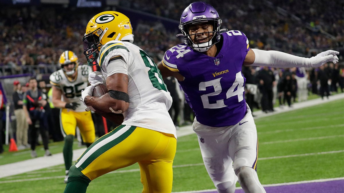 Green Bay Packers wide receiver Bo Melton (80) scores a touchdown reception against Minnesota Vikings safety Camryn Bynum (24) during their football game Sunday, December 31, 2023, at U.S. Bank Stadium in Minneapolis, Minnesota.
