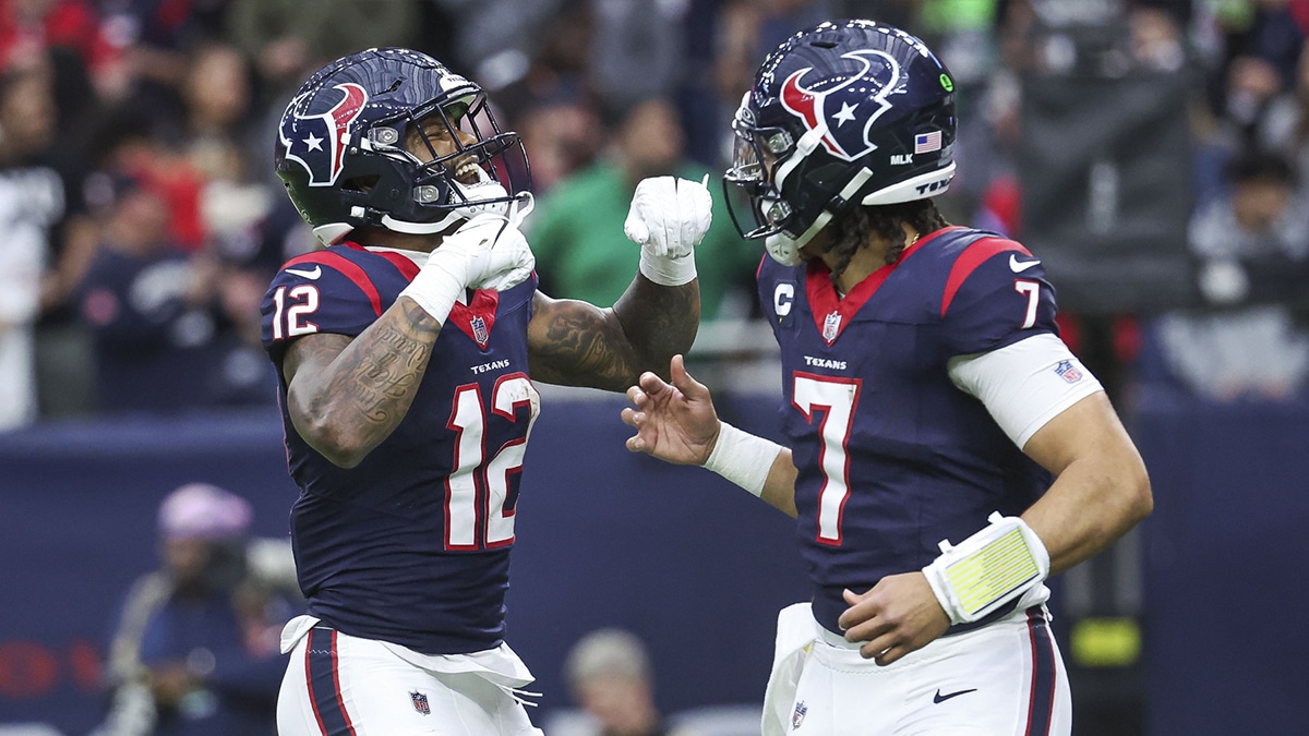 Houston Texans wide receiver Nico Collins (12) celebrates with quarterback C.J. Stroud (7) after a touchdown in a 2024 AFC wild card game against the Cleveland Browns at NRG Stadium.