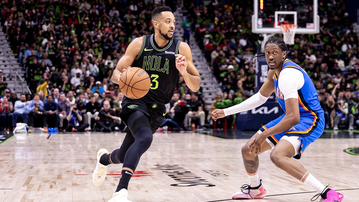 New Orleans Pelicans guard CJ McCollum (3) dribbles against Oklahoma City Thunder forward Jalen Williams (8) during the first half of game four of the first round for the 2024 NBA playoffs at Smoothie King Center.