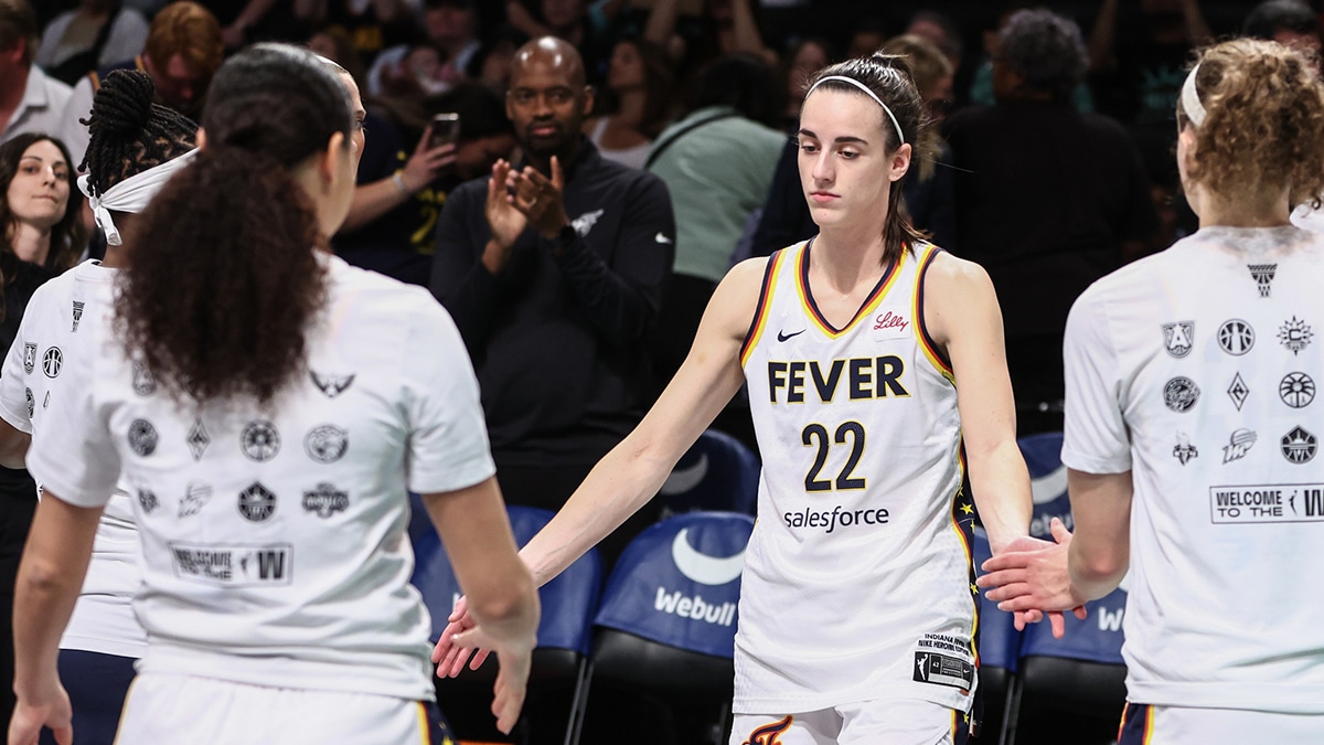 Indiana Fever guard Caitlin Clark (22) is greeted by her teammates during the opening lineup introductions against the New York Liberty.