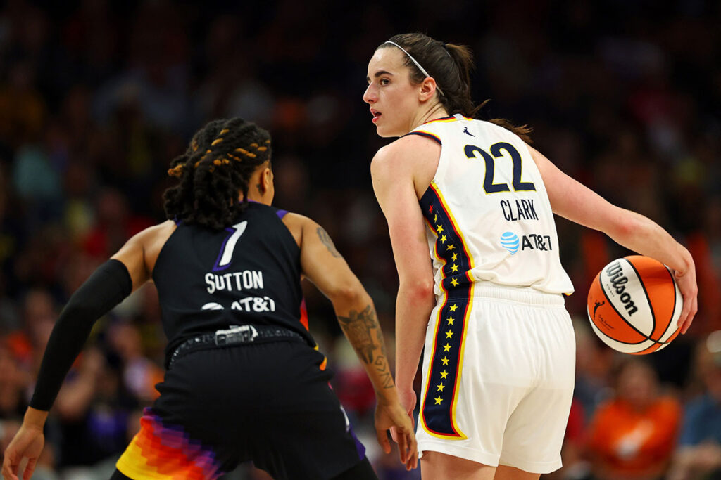 Indiana Fever guard Caitlin Clark (22) handles the ball against Phoenix Mercury guard Sug Sutton (1) during the second half at Footprint Center. 
