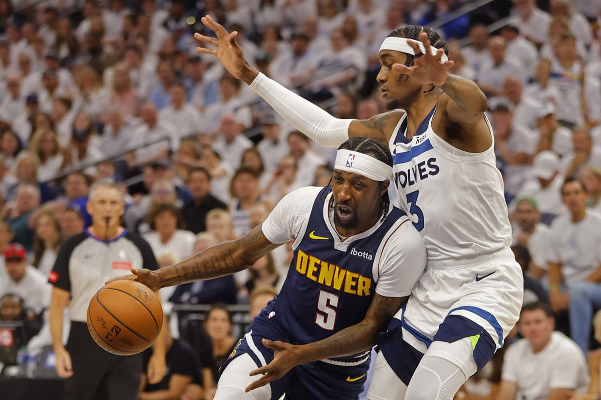 Denver Nuggets guard Kentavious Caldwell-Pope (5) works around Minnesota Timberwolves forward Jaden McDaniels (3) in the first quarter of game four of the second round for the 2024 NBA playoffs at Target Center.
