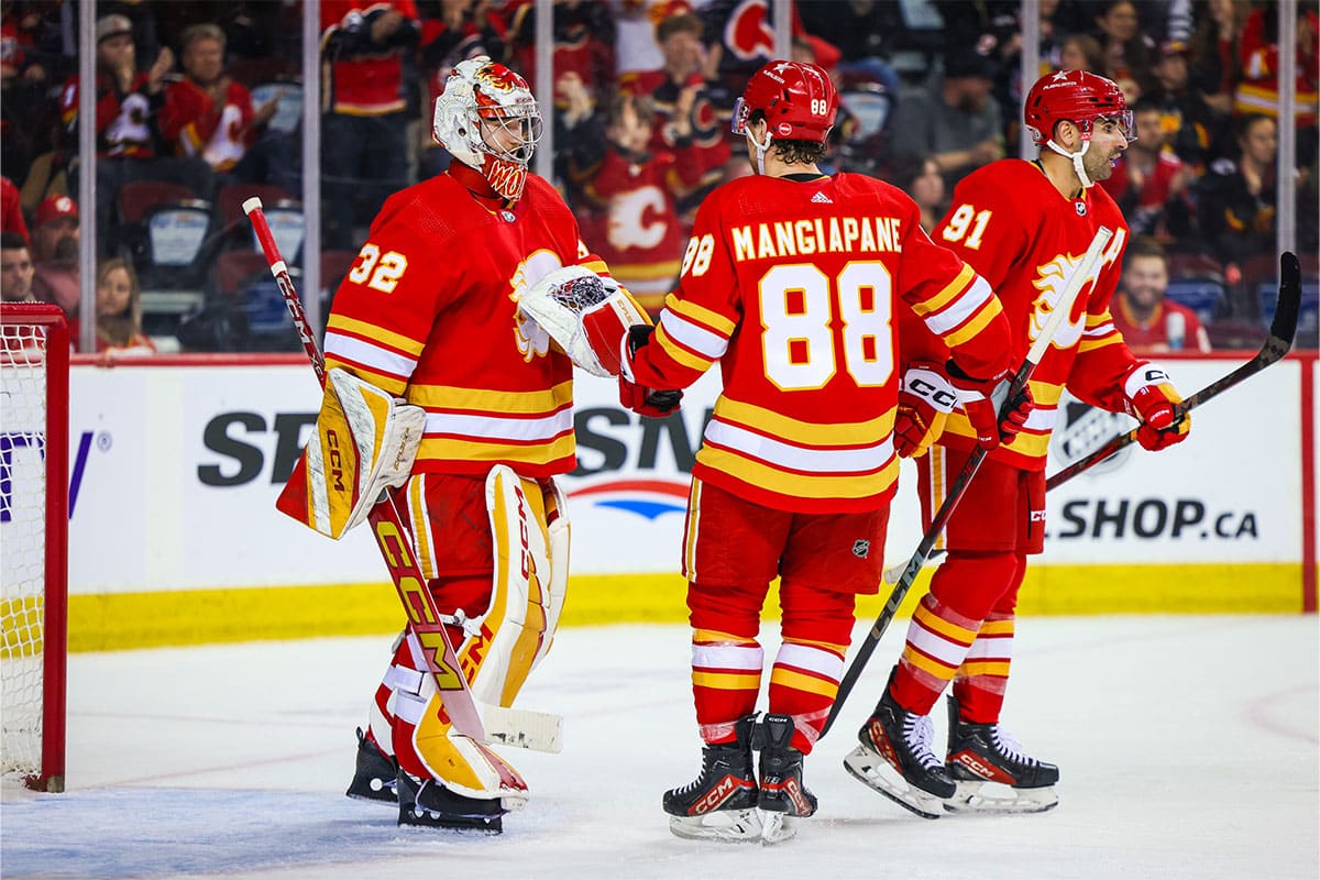 Calgary Flames goaltender Dustin Wolf (32) celebrate win with teammates after defeating San Jose Sharks at Scotiabank Saddledome.