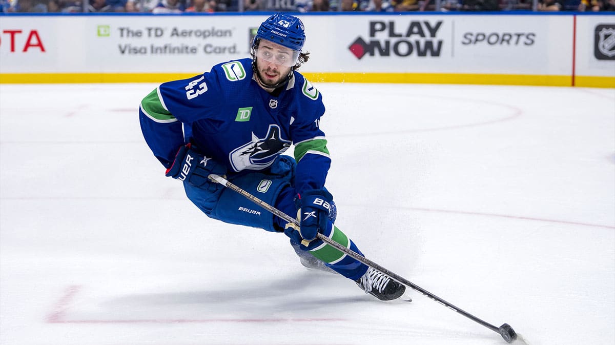 Vancouver Canucks defenseman Quinn Hughes (43) handles the puck against the Edmonton Oilers during the second period in game seven of the second round of the 2024 Stanley Cup Playoffs at Rogers Arena.