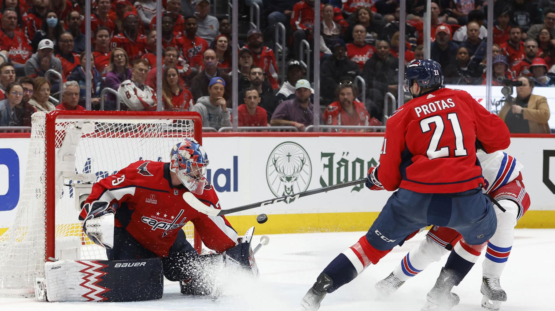Washington Capitals goaltender Charlie Lindgren (79) makes a save on New York Rangers center Mika Zibanejad (93) as Capitals center Aliaksei Protas (21) defends in the second period in game four of the first round of the 2024 Stanley Cup Playoffs at Capital One Arena.