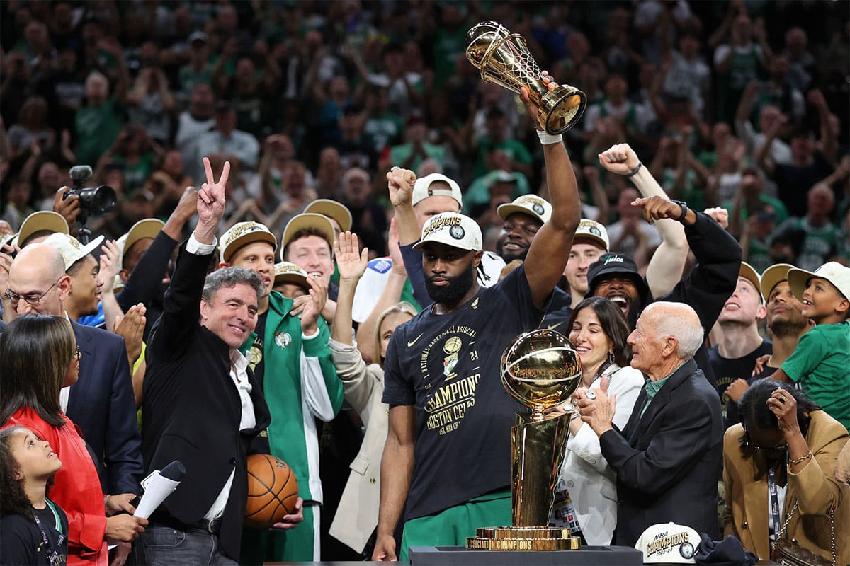 Boston Celtics guard Jaylen Brown (7) holds the MVP trophy after winning the 2024 NBA Finals against the Dallas Mavericks at TD Garden.