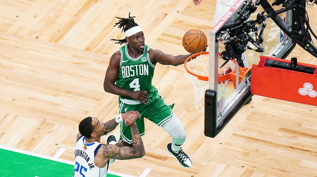 Boston Celtics guard Jrue Holiday (4) shoots against Dallas Mavericks forward P.J. Washington (25) in the third quarter during game five of the 2024 NBA Finals at TD Garden.