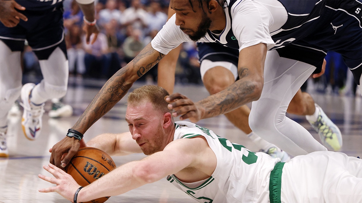 Boston Celtics forward Sam Hauser (30) battles for the ball against Dallas Mavericks center Daniel Gafford (21) during the first quarter during game four of the 2024 NBA Finals at American Airlines Center.