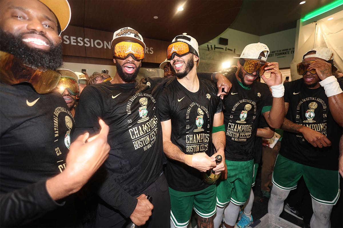 The Boston Celtics celebrate in the locker room after winning the 2024 NBA Finals against the Dallas Mavericks at TD Garden.
