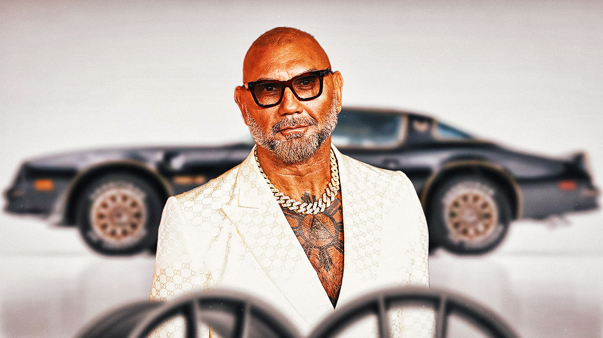 Dave Bautista in front of a car from his collection.