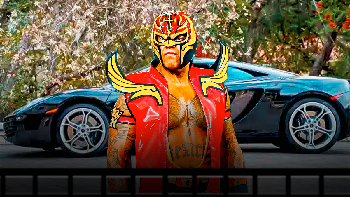 Rey Mysterio in front of a car from his collection.