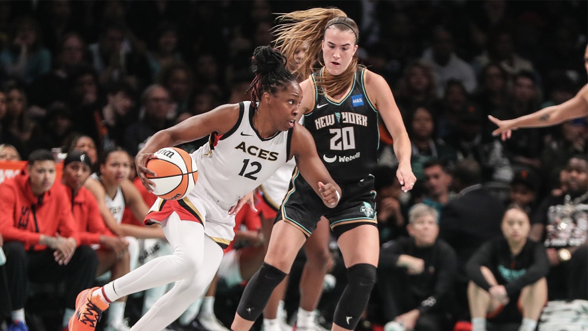 Las Vegas Aces guard Chelsea Gray (12) drives around New York Liberty guard Sabrina Ionescu (20) in the third quarter during game three of the 2023 WNBA Finals.