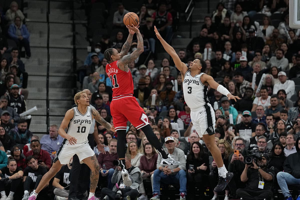 Chicago Bulls forward DeMar DeRozan (11) shoots over San Antonio Spurs forward Keldon Johnson (3) in the second half at Frost Bank Center.