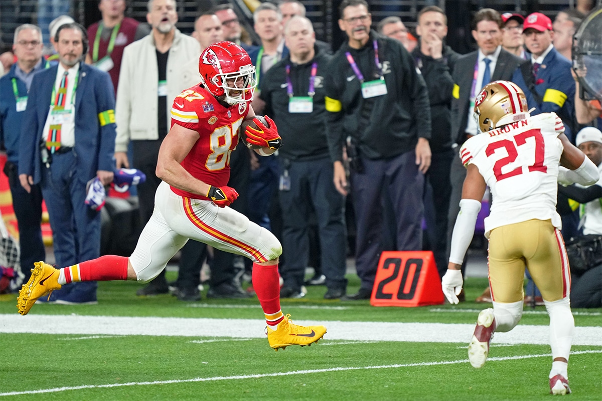 Kansas City Chiefs tight end Travis Kelce (87) runs with the ball against San Francisco 49ers safety Ji'Ayir Brown (27) during the fourth quarter of Super Bowl LVIII at Allegiant Stadium. 