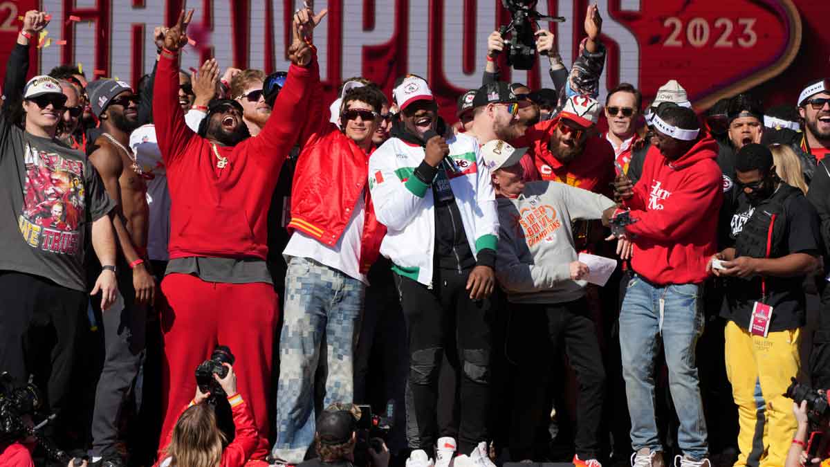 Kansas City Chiefs defensive tackle Chris Jones (95) addresses the crowd on stage with quarterback Patrick Mahomes (15) during the celebration of the Kansas City Chiefs winning Super Bowl LVIII