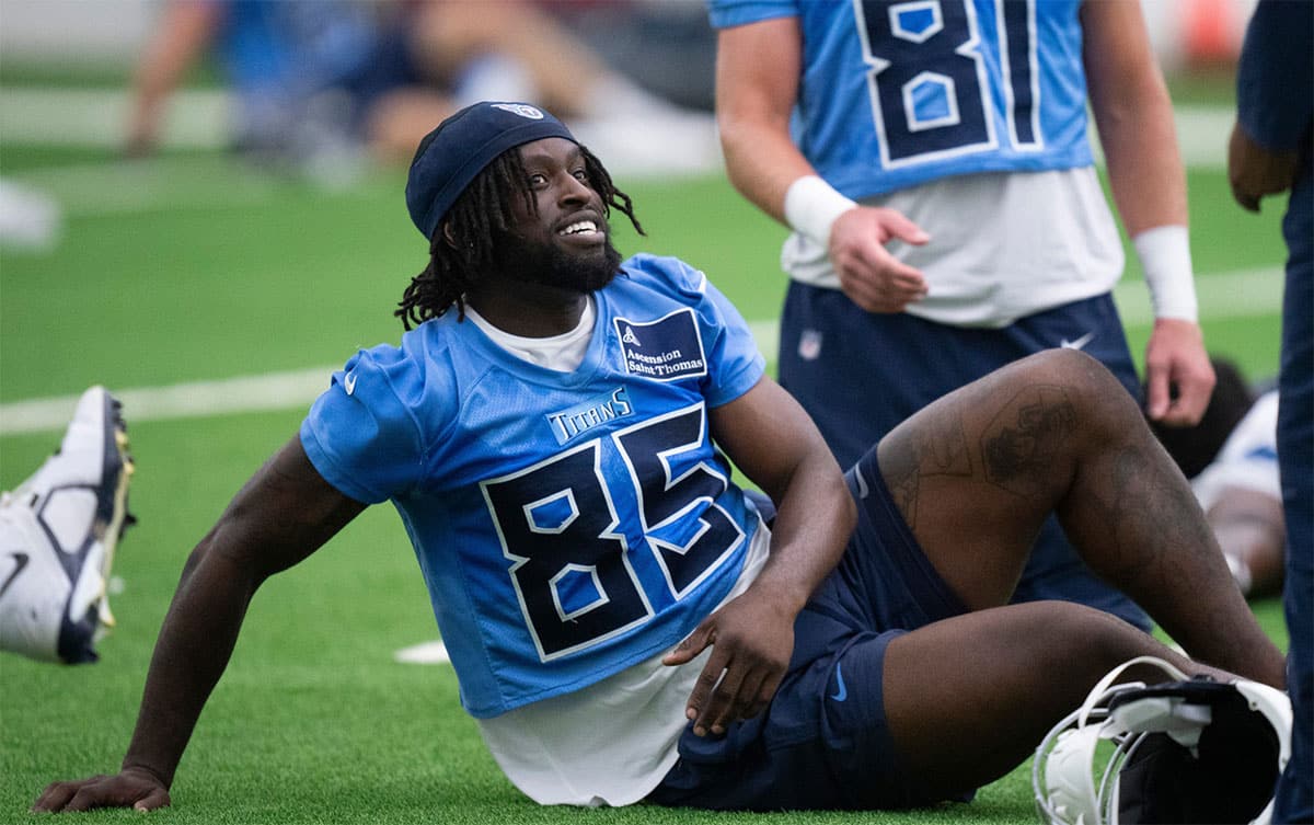 Tight end Chig Okonkwo (85) talks with a coach during the Tennessee Titans mandatory mini-camp at Ascension Saint Thomas Sports Park