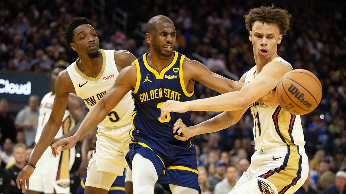 Golden State Warriors guard Chris Paul (3) passes away from defensive pressure by New Orleans Pelicans forward Herbert Jones (5) and guard Dyson Daniels (11) during the fourth quarter at Chase Center. 