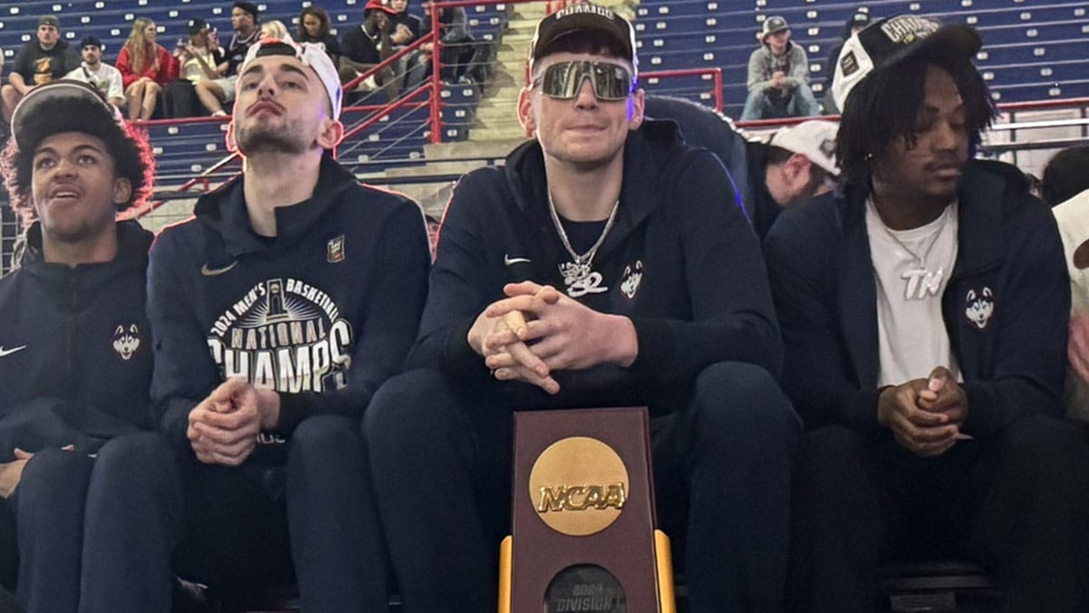 UConn players with the national championship trophy. From left, Jaylin Stewart, Alex Karaban, Donovan Clingan and Tristen Newton.
