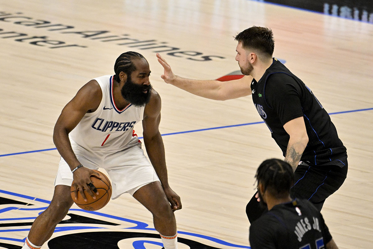 LA Clippers guard James Harden (1) looks to move the ball past Dallas Mavericks guard Luka Doncic (77) during the fourth quarter during game six of the first round for the 2024 NBA playoffs at American Airlines Center.