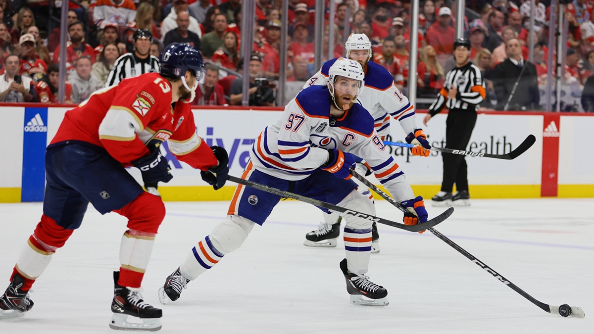 Edmonton Oilers forward Connor McDavid (97) controls the puck against Florida Panthers forward Sam Reinhart (13) during the third period in game one of the 2024 Stanley Cup Final at Amerant Bank Arena.