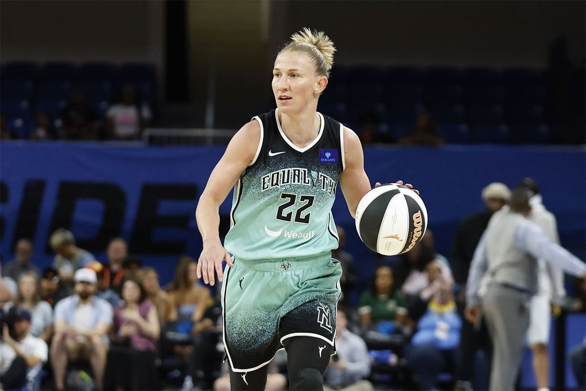 New York Liberty guard Courtney Vandersloot (22) brings the ball up court against the Chicago Sky during the first half of a WNBA game at Wintrust Arena. 