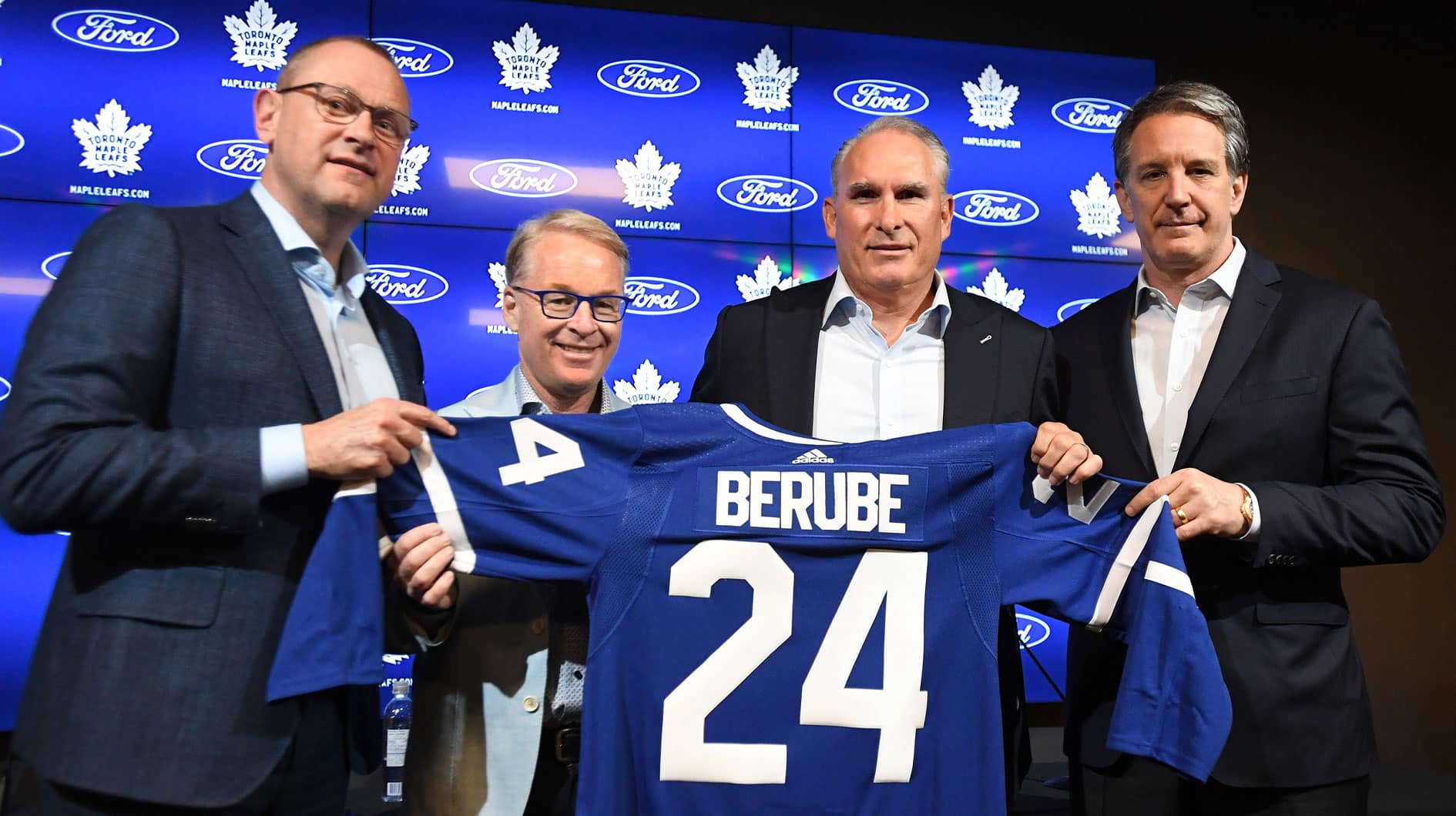 Newly appointed Toronto Maple Leafs head coach Craig Berube (second right) poses with a team jersey alongside (from left) general manager Brad Treliving, Maple Leaf Sport and Entertainment president Keith Pelley and club president Brendan Shanahan at Ford Performance Centre
