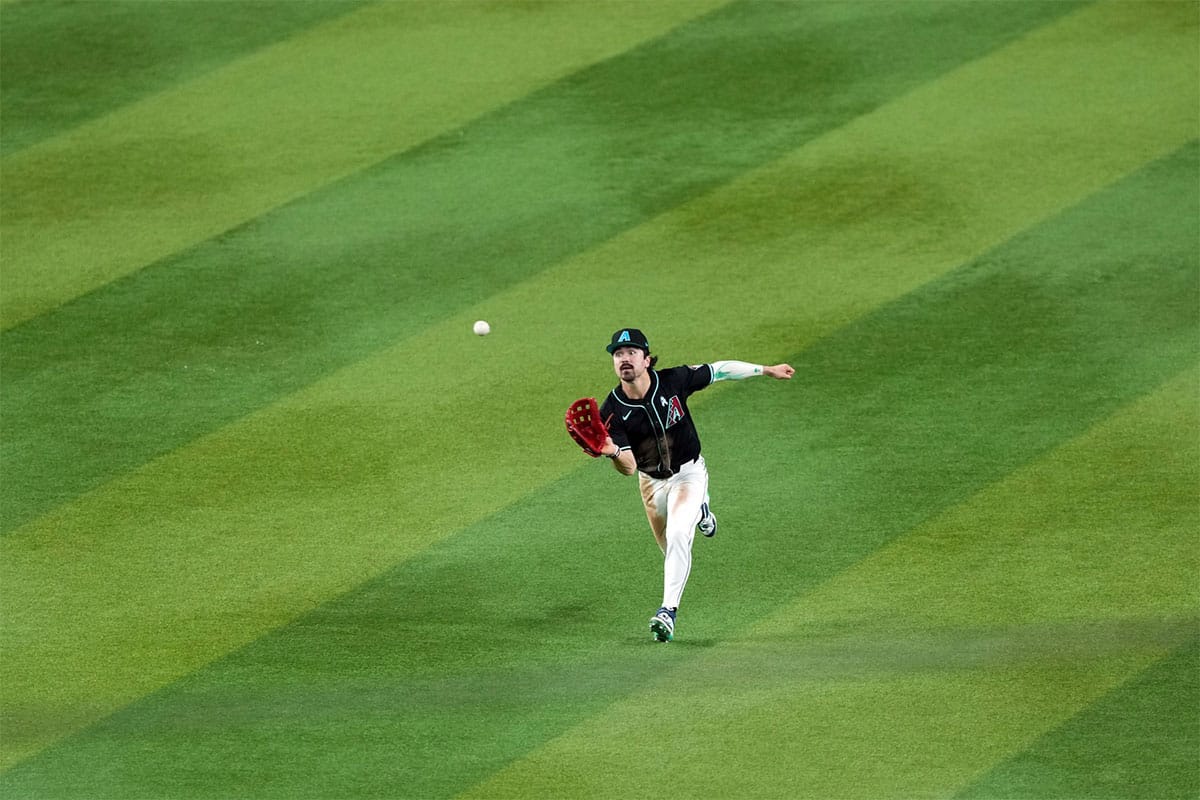 Arizona Diamondbacks outfielder Corbin Carroll (7) runs down a fly ball against the Chicago White Sox during the seventh inning at Chase Field.