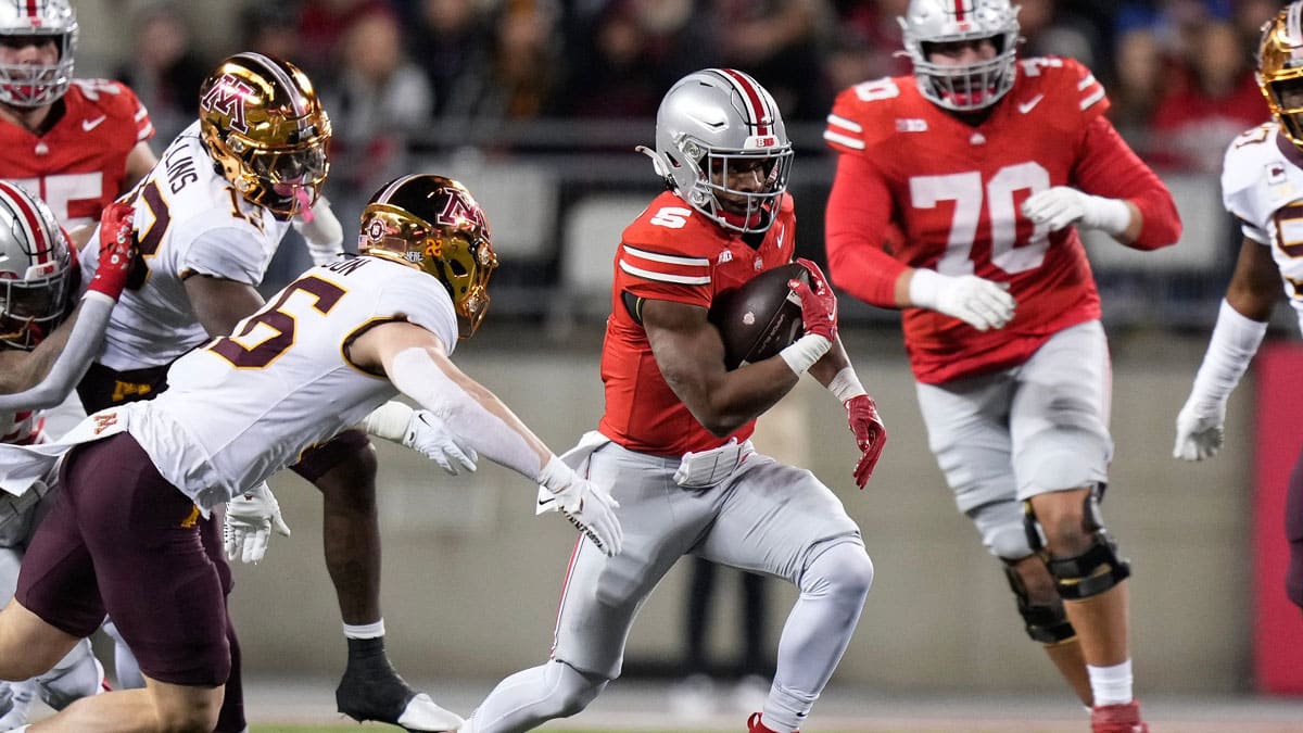 Ohio State Buckeyes running back Dallan Hayden (5) runs past Minnesota Golden Gophers defensive back Coleman Bryson (16) during the second half of the NCAA football game at Ohio Stadium.