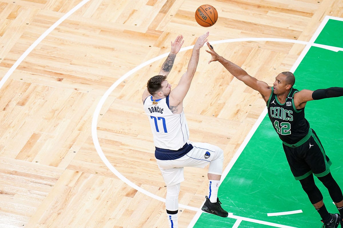 Jun 9, 2024; Boston, Massachusetts, USA; Dallas Mavericks guard Luka Doncic (77) shoots against Boston Celtics center Al Horford (42) in the first quarter during game two of the 2024 NBA Finals at TD Garden. Mandatory Credit: David Butler II-USA TODAY Sports