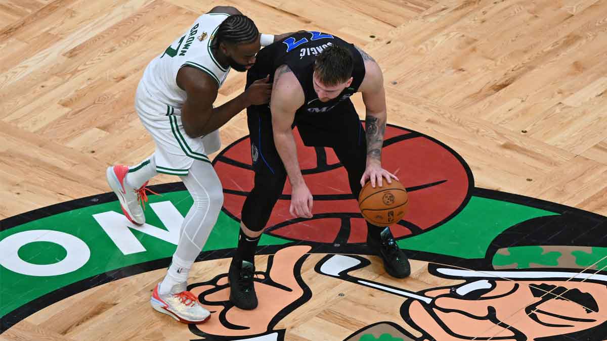 Jun 6, 2024; Boston, Massachusetts, USA; Dallas Mavericks guard Luka Doncic (77) controls the ball against Boston Celtics guard Jaylen Brown (7) during the second half of game one of the 2024 NBA Finals at TD Garden. Mandatory Credit: Peter Casey-USA TODAY Sports