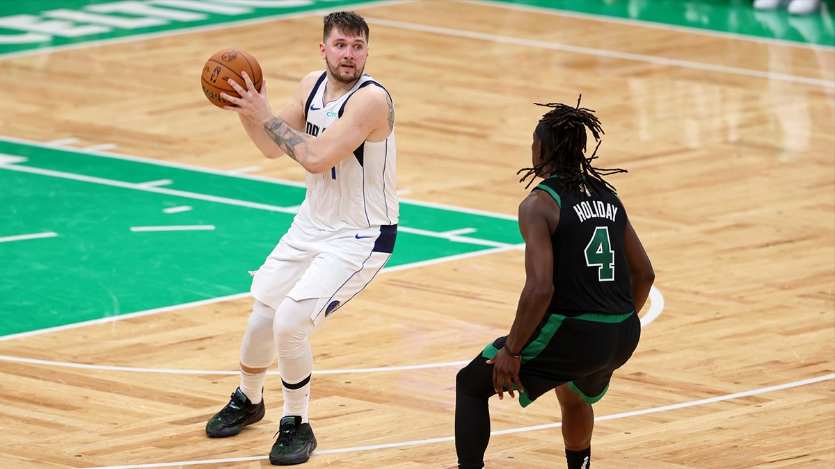 Jun 9, 2024; Boston, Massachusetts, USA; Dallas Mavericks guard Luka Doncic (77) shoots the ball against Boston Celtics guard Jaylen Brown (7) during the fourth quarter in game two of the 2024 NBA Finals at TD Garden. Mandatory Credit: Peter Casey-USA TODAY Sports