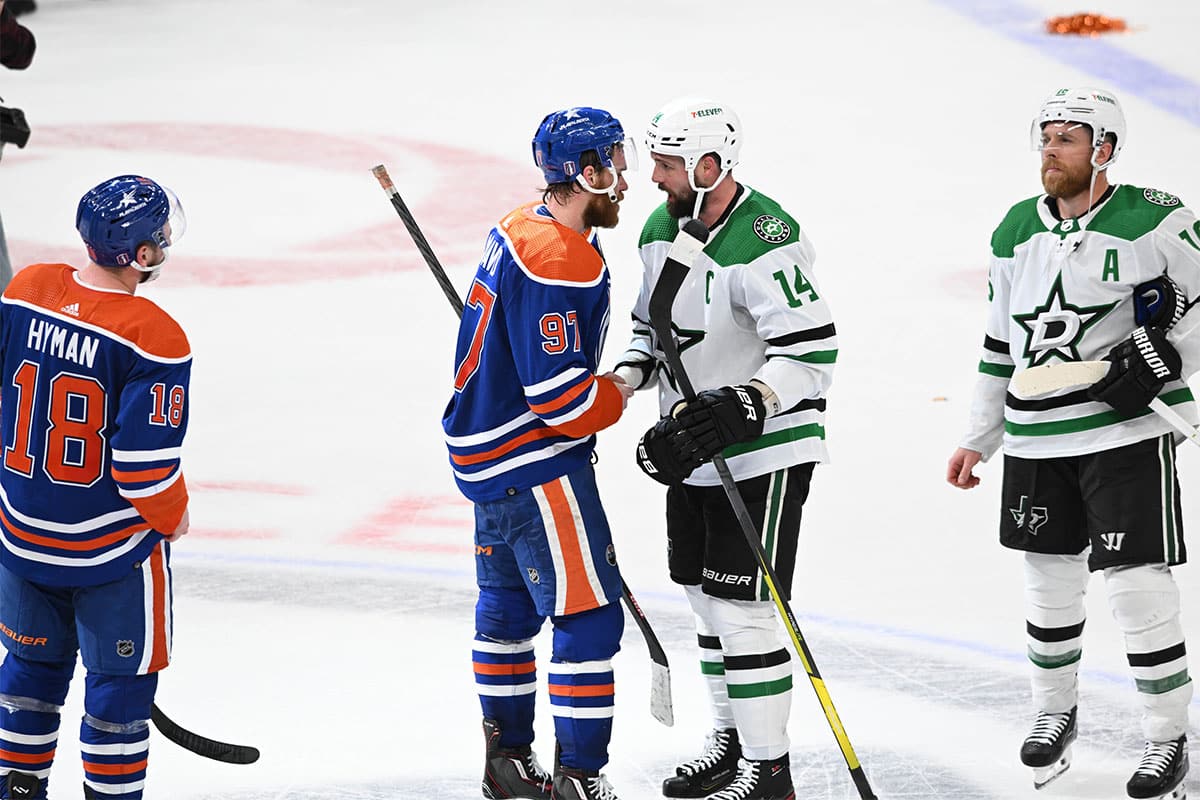  Oilers centre Connor McDavid (97) shakes hands with Dallas Stars left winger Jamie Benn (14) at the end of the third period in game six of the Western Conference Final of the 2024 Stanley Cup Playoffs at Rogers Place.