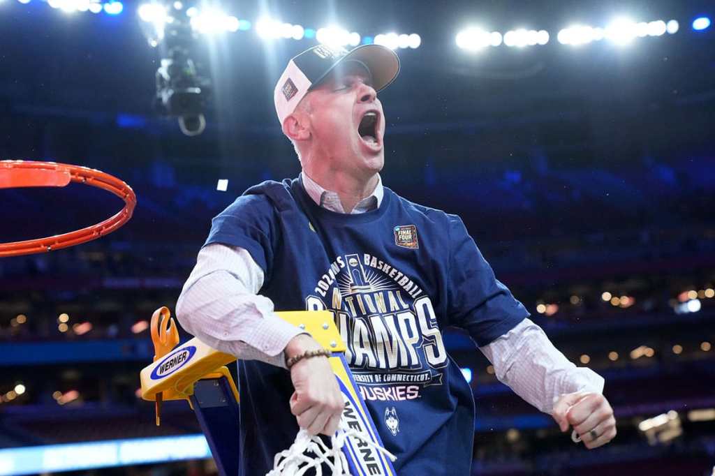 Apr 8, 2024; Glendale, Ariz, U.S.; Connecticut Huskies head coach Dan Hurley cuts down the cut after defeating the Purdue Boilermakers in the national championship game of the Final Four of the 2024 NCAA Tournament at State Farm Stadium in Glendale on April 8, 2024.