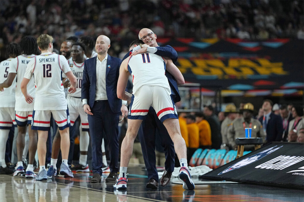 Connecticut Huskies head coach Dan Hurley hugs forward Alex Karaban (11) during the second half of the national championship game of the Final Four of the 2024 NCAA Tournament at State Farm Stadium. 