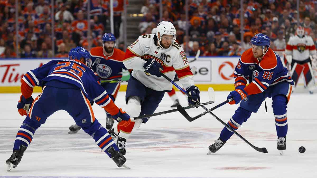 Florida Panthers center Aleksander Barkov (16) skates with the puck defended by Edmonton Oilers defenseman Darnell Nurse (25) and defenseman Philip Broberg (86) in the first period in game three of the 2024 Stanley Cup Final at Rogers Place.