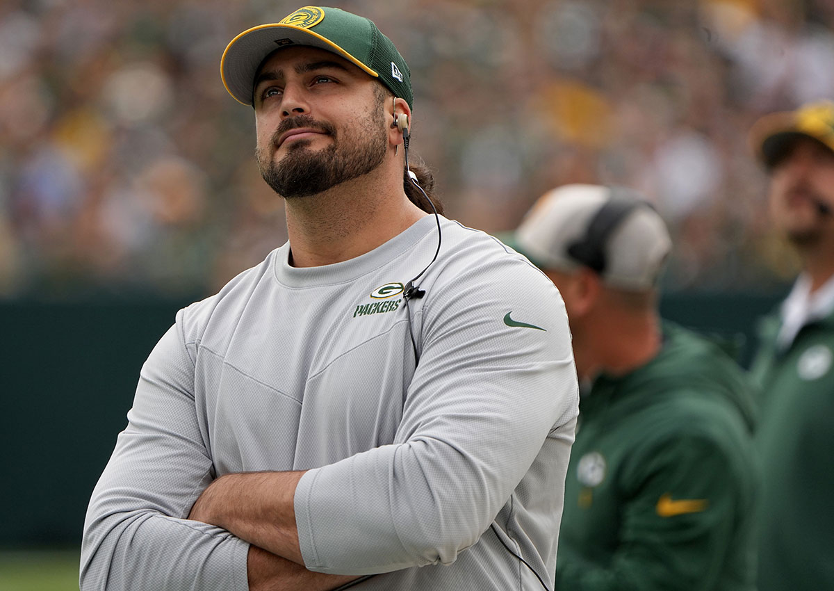 Injured Green Bay Packers offensive tackle David Bakhtiari watches his team during the first quarter of their game against the New Orleans Saints at Lambeau Field.