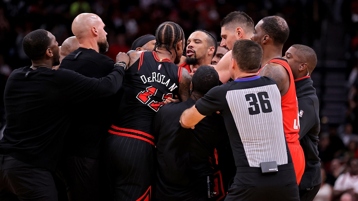 Chicago Bulls forward DeMar DeRozan (11) and Houston Rockets forward Dillon Brooks (9) are separated by game officials team officials during the third quarter at Toyota Center.