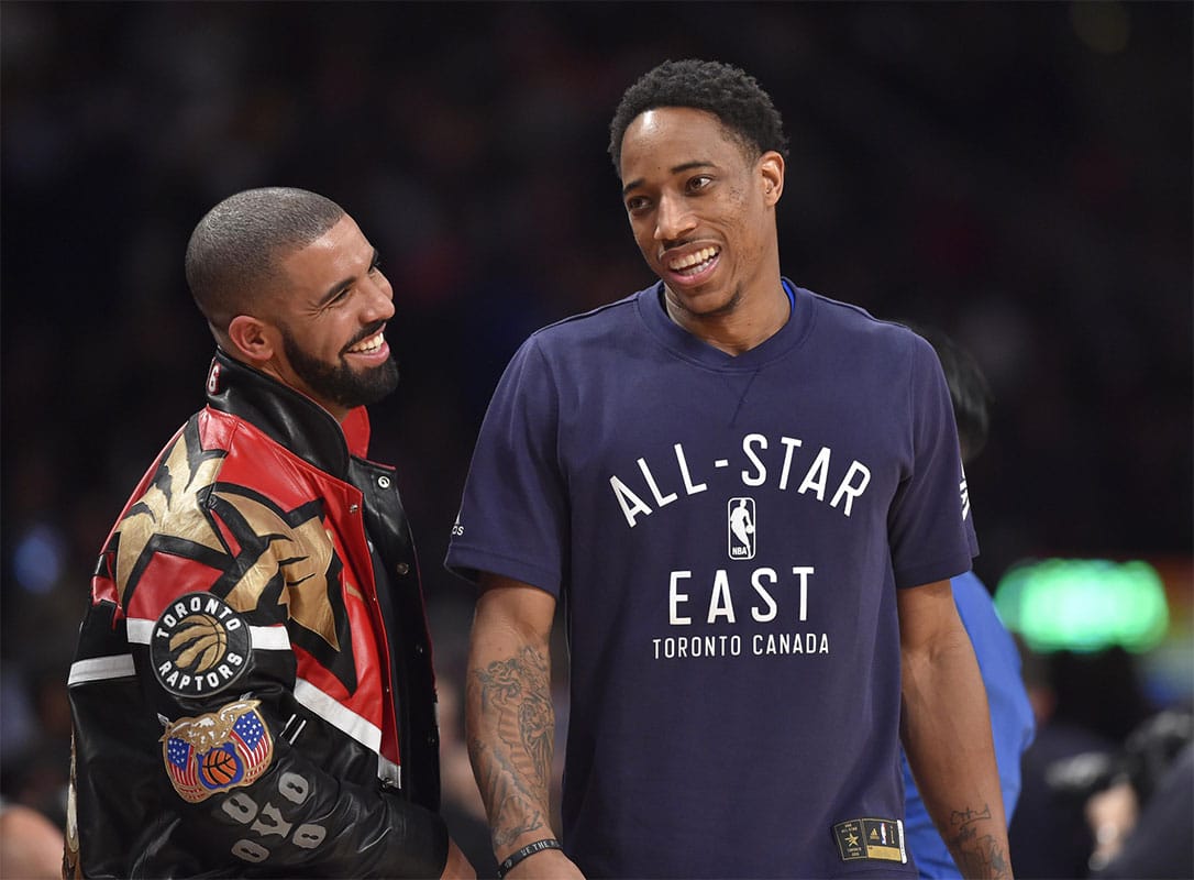 Eastern Conference guard DeMar DeRozan of the Toronto Raptors (right) talks with Drake in the second half during the NBA All Star Game at Air Canada Centre.